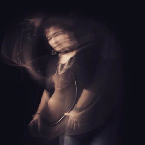 Portrait photo of woman standing with blurred forms of her movement from anxiety